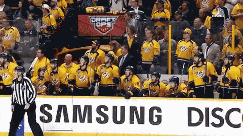 a group of hockey players are standing in front of a samsung advertisement