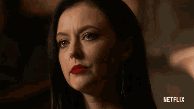 a close up of a woman 's face with netflix written on the bottom right