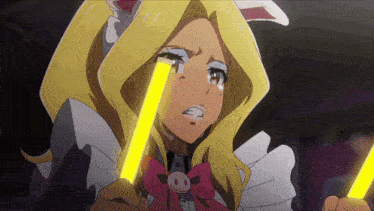 a girl with blonde hair is crying while holding a yellow light stick