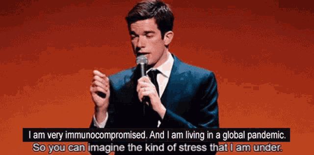 a man in a suit speaking into a microphone