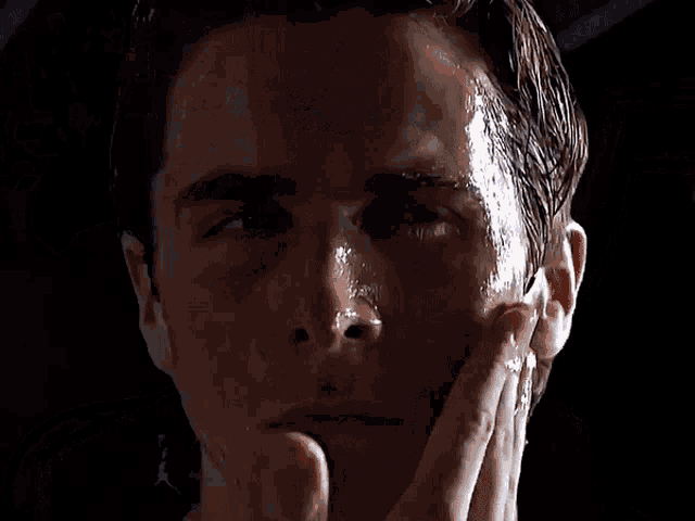 a man with sweat on his face looks at the camera