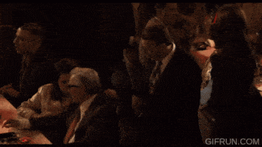 a gif from gifrun.com shows a man sitting at a table