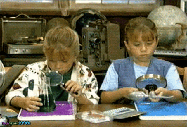 two girls looking through magnifying glasses with the year 1990s in the lower right corner
