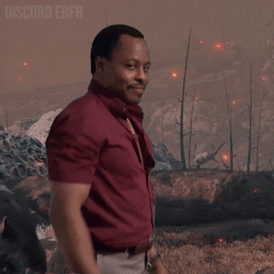 a man in a maroon shirt is clapping in front of a monster with the words discord erfr written above him