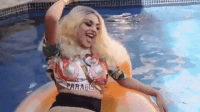 a woman is floating on an inflatable raft in a swimming pool .