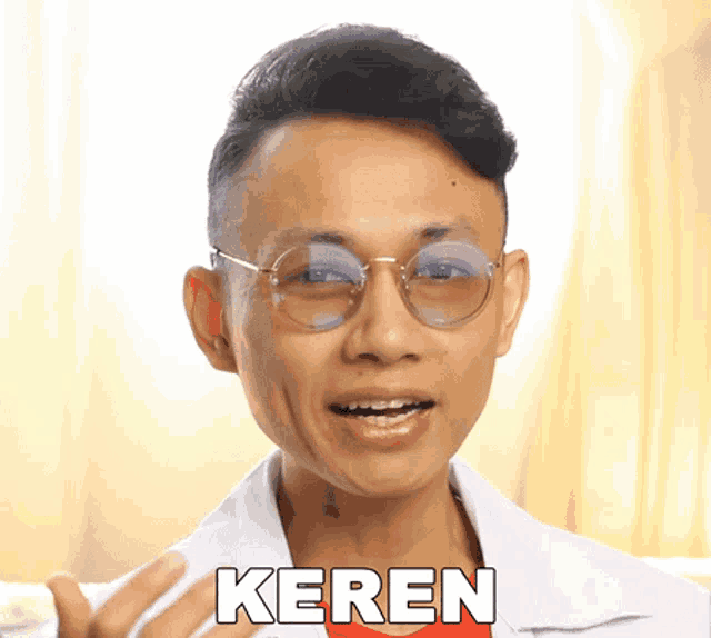 a man wearing glasses and a white shirt with the word keren on the bottom