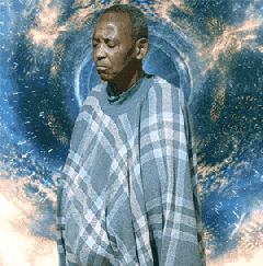 a man wearing a plaid sweater is standing in front of a blue background