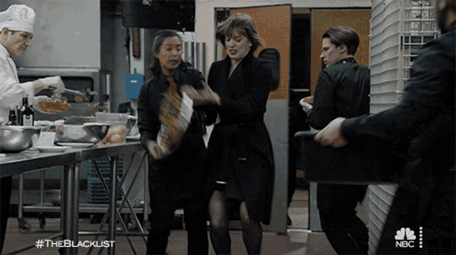 a group of people standing in a kitchen with the hashtag #theblacklist on the bottom