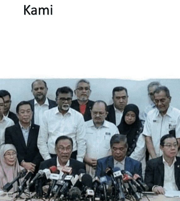 a group of people are standing in front of microphones with the word kami on the bottom