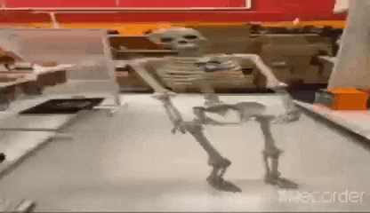 a skeleton is standing on a counter in a store .