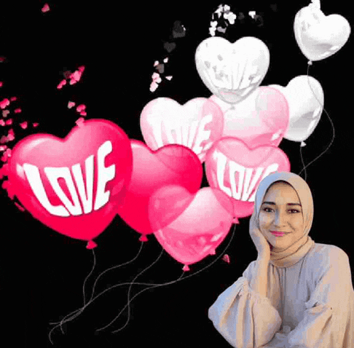 a woman wearing a hijab is standing in front of a bunch of heart shaped balloons .