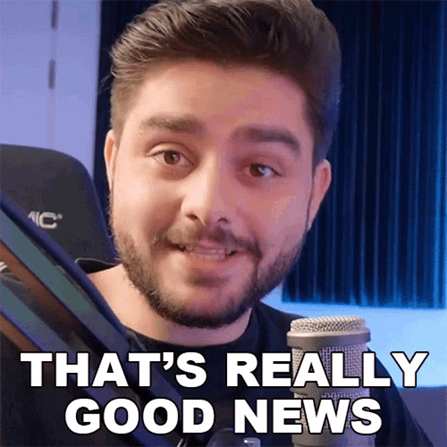 a man with a beard says that 's really good news in front of a microphone