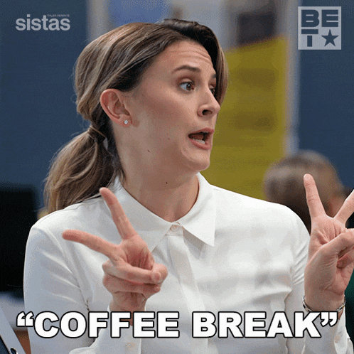 a woman in a white shirt is making a peace sign and says " coffee break "