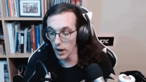 a man with long hair is wearing headphones and a microphone .