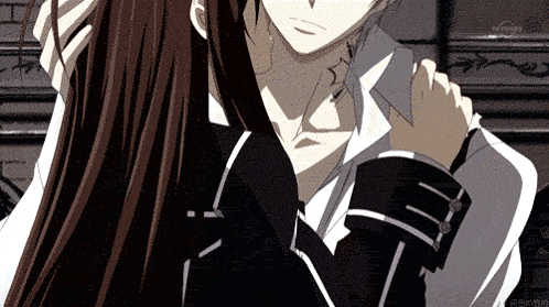 a man and a woman are hugging and the man is holding the woman 's neck