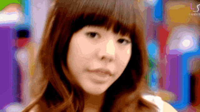 a blurry picture of a woman 's face with the letters ls on the bottom