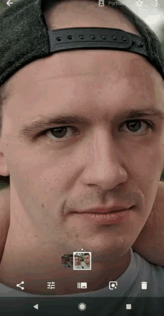 a close up of a man 's face on a phone