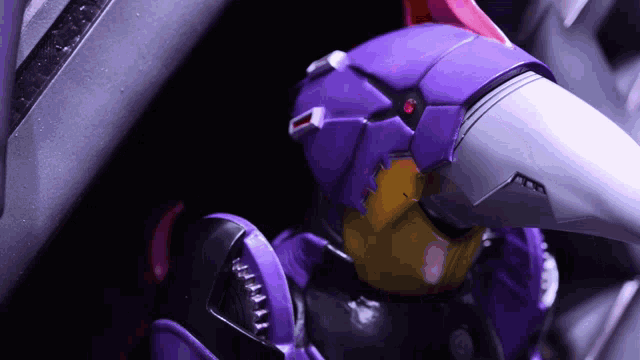 a close up of a purple robot with a red light on its head
