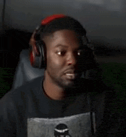 a man wearing headphones is sitting in a chair looking at the camera .