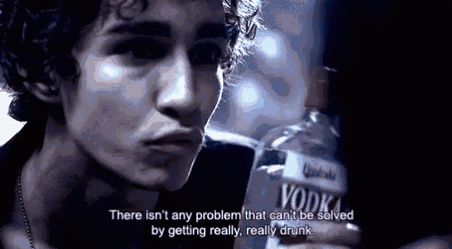 a man is holding a bottle of vodka and saying there isn 't any problem that can 't be solved