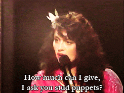 a woman speaking into a microphone with the words " how much can i give i ask you stud puppets "