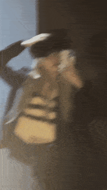 a blurry picture of a person wearing a black hat