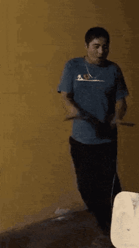 a man in a blue quiksilver shirt is dancing