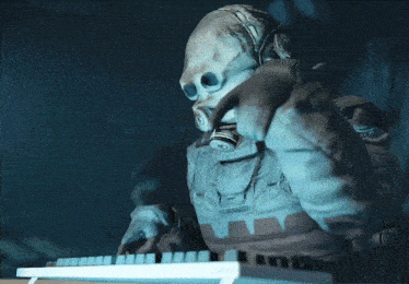 a person wearing a gas mask is typing on a computer keyboard