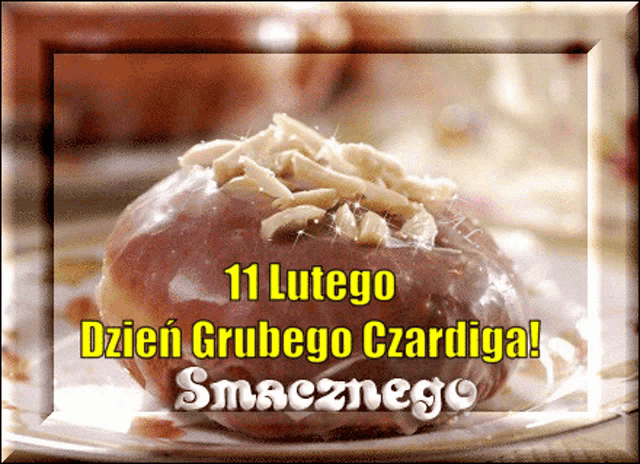 a picture of a donut with nuts on top and the words 11 lutego dzien grubego czardiga smacznego