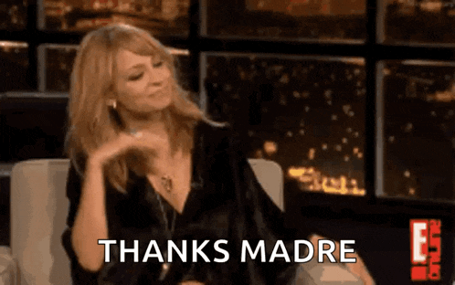 a woman is sitting in a chair and saying thanks madre