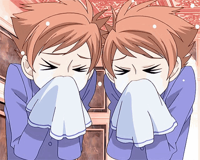 two anime characters are blowing their noses with a towel