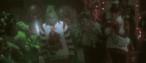 a group of people are dancing in a dark room and the words feliz navidad are on the bottom