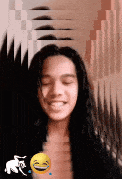 a girl with long hair is smiling with a yellow smiley face behind her