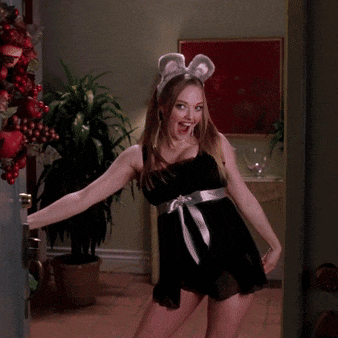 a woman in a black dress and bunny ears is standing in a doorway