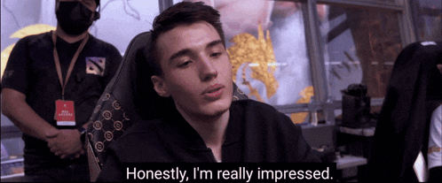 a man sitting in a chair with the words " honestly i 'm really impressed " next to him