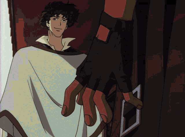 a man in a white poncho is smiling while another person holds a door handle