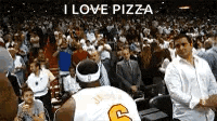 a basketball player with the number 6 on his jersey stands in front of a crowd of people .