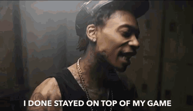a man with a tattoo on his neck is saying i done stayed on top of my game