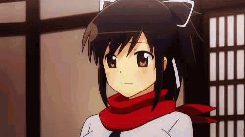 a girl with a red scarf around her neck is looking at the camera