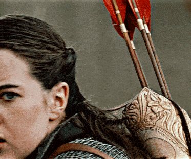a woman in a knight 's armor holds a bow and arrow