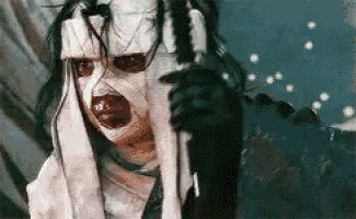 a woman with bandages on her face is holding a knife and looking at the camera .