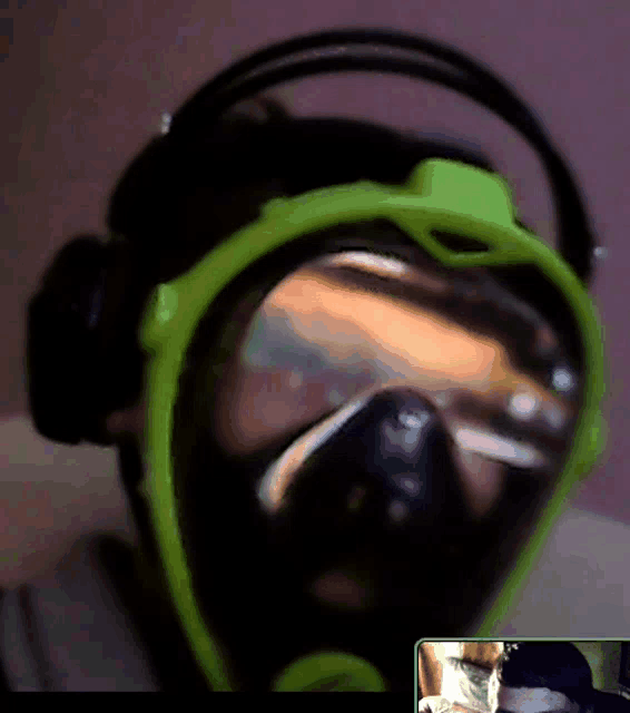 a person wearing headphones and a green mask