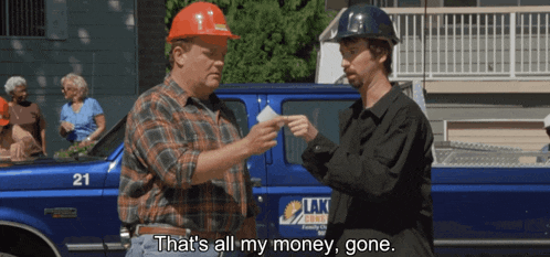 two men are standing in front of a blue truck that says lak on it