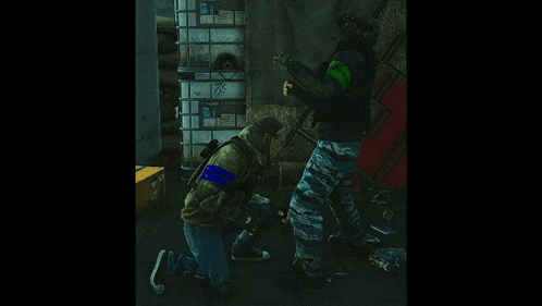 a man with a green armband on his arm kneeling down