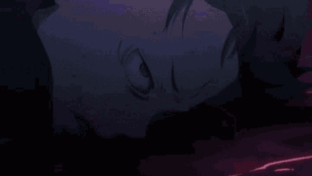 a group of dolphins are swimming in the ocean in a dark purple background .