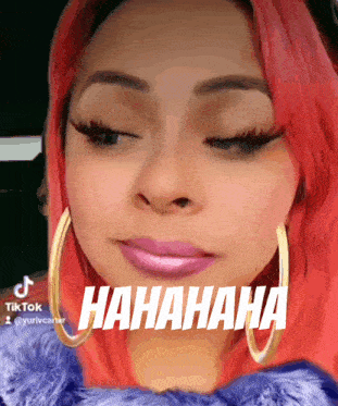 a woman with red hair is wearing hoop earrings and says '  hahaha '