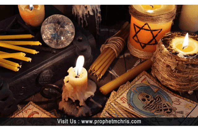a picture of candles and tarot cards with the website www.prophetmchris.com in the upper right corner