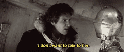 a man in a fur coat is talking to a robot and says i don 't want to talk to her .