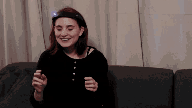 a woman with a light on her head is smiling