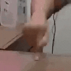 a person is standing in front of a counter in a kitchen .
